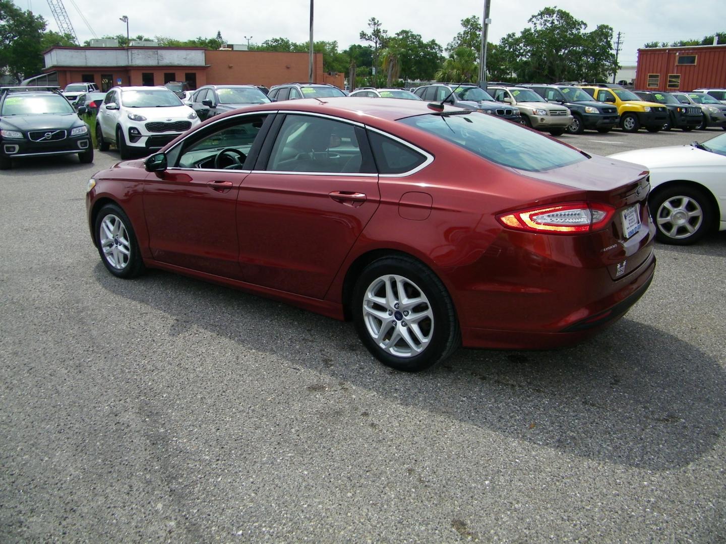 2014 Orange /Black Ford Fusion SE (3FA6P0HD7ER) with an 1.5L L4 DOHC 16V engine, Automatic transmission, located at 4000 Bee Ridge Road, Sarasota, FL, 34233, (941) 926-0300, 27.298664, -82.489151 - Photo#3